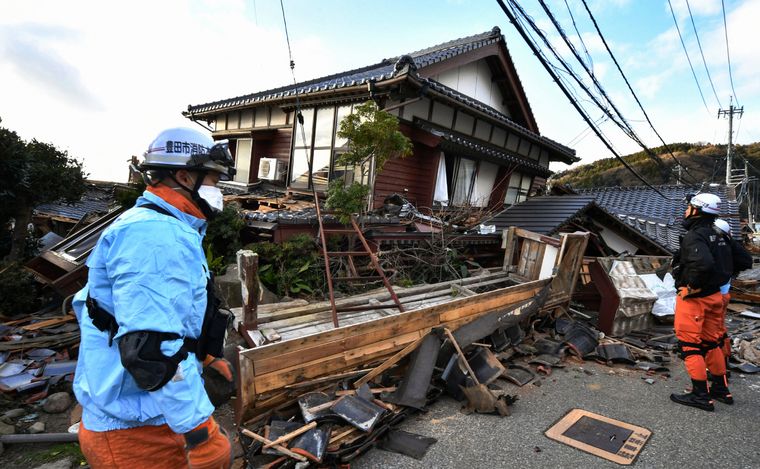 FOTO: Los bomberos inspeccionan casas de madera derrumbadas en Wajima.