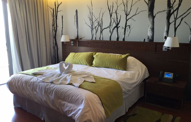 Habitaciones espaciosas, con camas king size y detalles en madera.