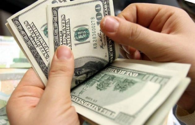 El dólar, en baja con relación al cierre del viernes.