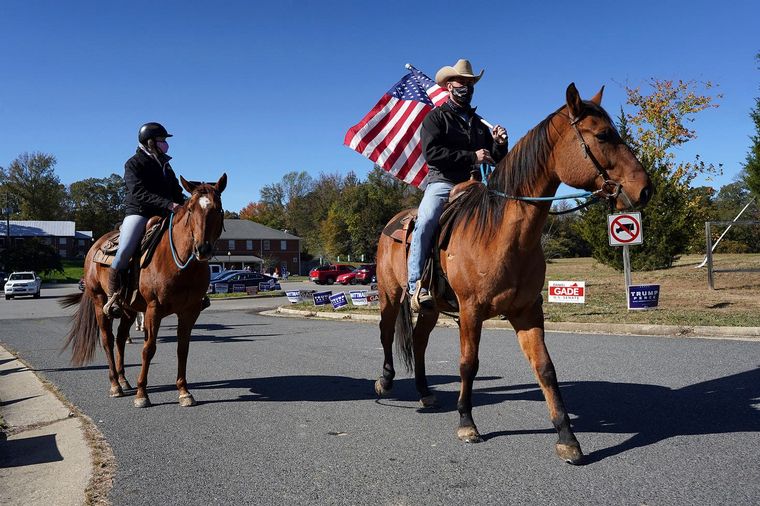 Una pareja cabalga al punto de votación (Fuente: AP).